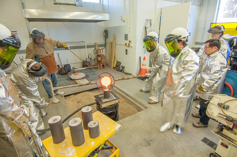 Students and faculty working in the large casting area