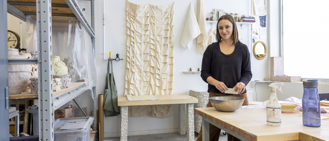 Ceramics student working in her studio