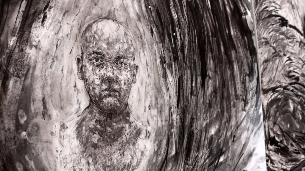 large intricate charcoal drawing of a face