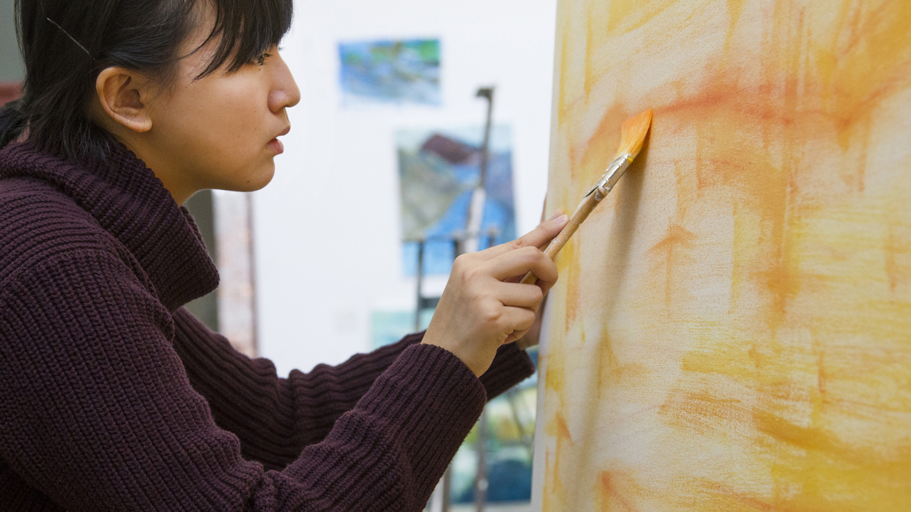 student painting a large canvas